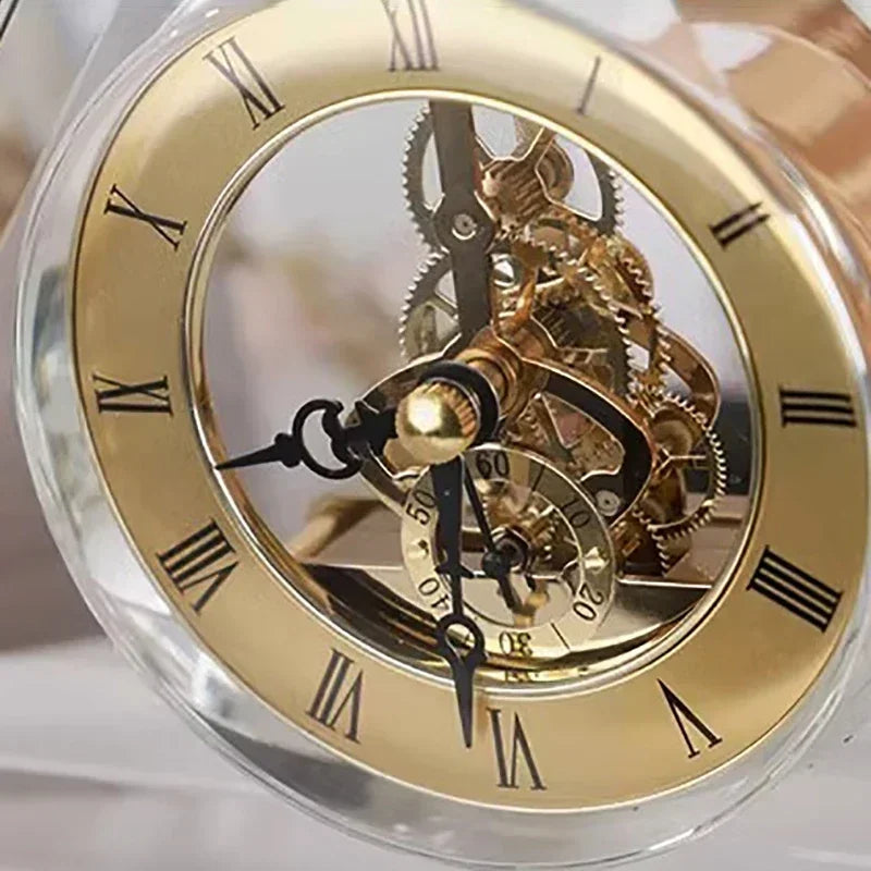 Crystal tabletop clock - Dunley features clear beveled glass showcasing gold-toned gears. Black Roman numerals and ornate hands complement its elegant, skeleton-style design, perfect for any desk or mantel.