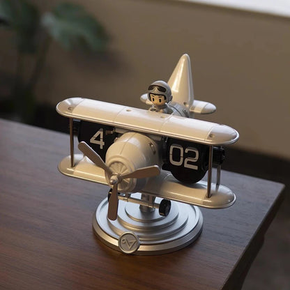 Close-up of flip clock display showing time on biplane wings