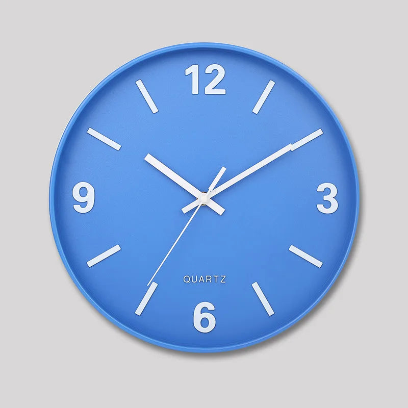 Modern Silent Wall Clock - Densford features a blue face with white markers and hands, emphasizing a minimalist design. Perfectly silent, this elegant clock enhances any room's decor.