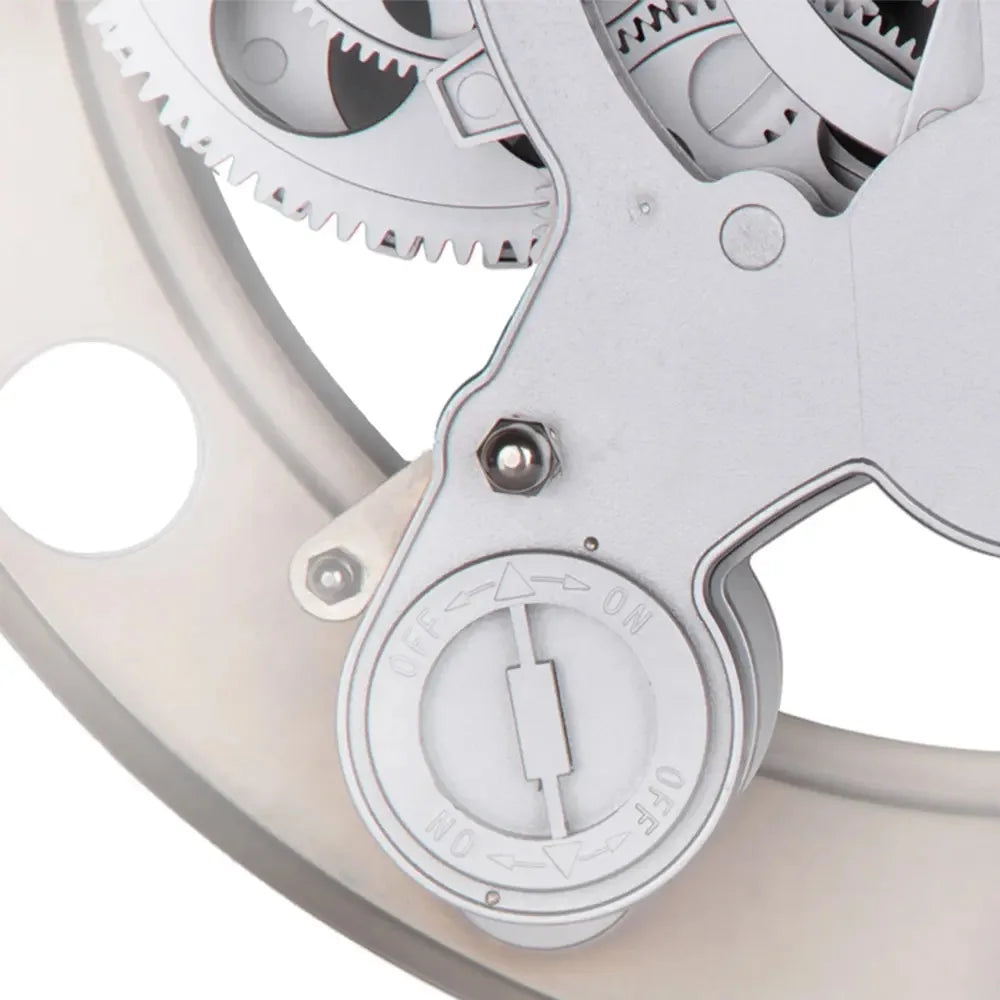 Modern Wall Clock Design - Elverton: Close-up of exposed mechanical gear train with manual ON ↔ OFF selector, resembling a quarter-turn valve actuator, integral to the clock's artistic and functional appeal.