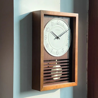 Japanese Wall Clock - Lexton: A minimalist wall-mounted pendulum clock with a wood case, visible brass pendulum, and a DODEKA marked dial, offering tranquility and elegance to any home decor.