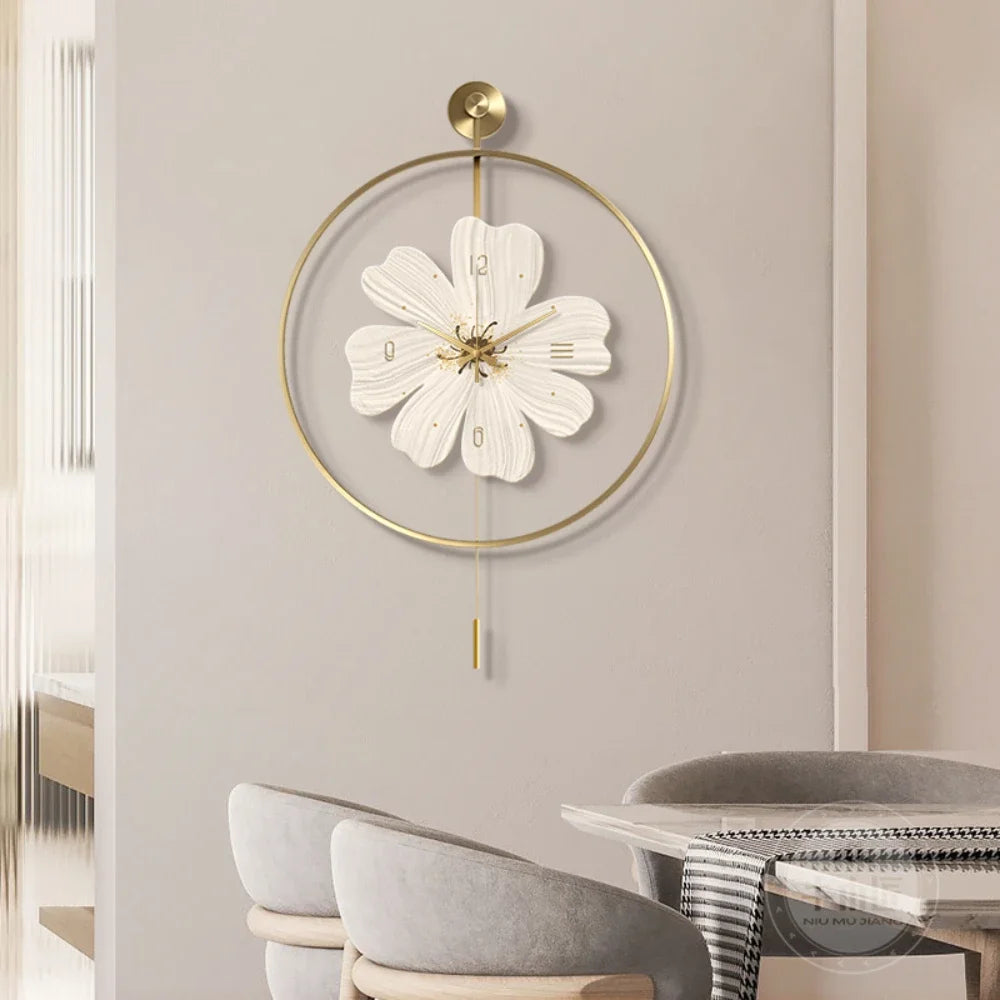 Flower wall clock - Fenton: A white floral-inspired clock with brass accents, elegantly suspended in a brass-colored hoop, adding a modern touch to the minimalist setting with neutral tones.