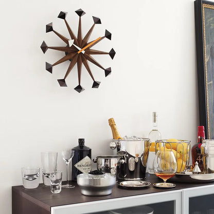 Decorative wall clocks modern - Drayen A mid-century design clock with geometric points, elegantly positioned above a chic home bar setup, embodying retro-modern style. 