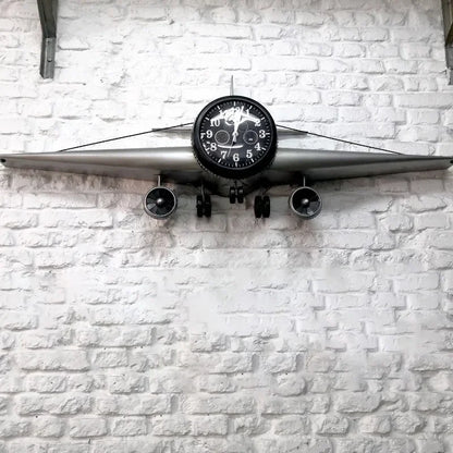 Industrial airplane wall clock mounted above white console table in modern living room