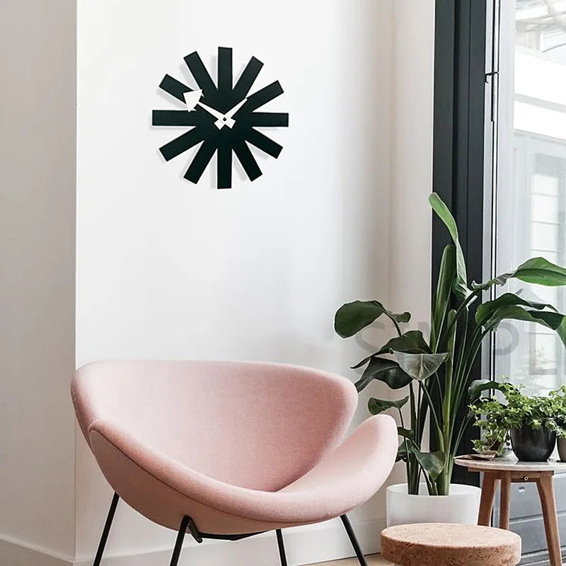 Packaged black metal wall clock with protective wrapping and mounting hardware