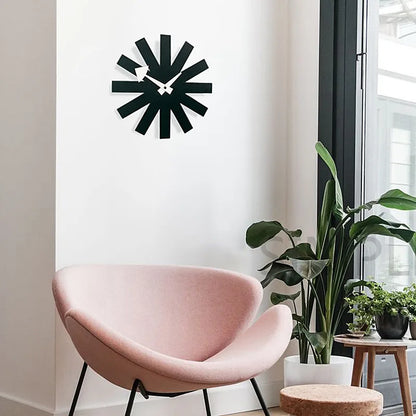 Packaged black metal wall clock with protective wrapping and mounting hardware