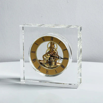 Crystal tabletop clock - Dunley: A clear glass-encased clock featuring a gold-tone skeleton dial with Roman numerals and visible brass gears, perfect for enhancing any desk or mantel with modern elegance.