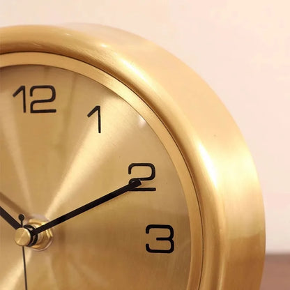 Brass Table Clock - Helric: A close-up of a round, metallic-gold clock face with black numerals and hands, showcasing timeless elegance and sophistication for any desk or mantel.