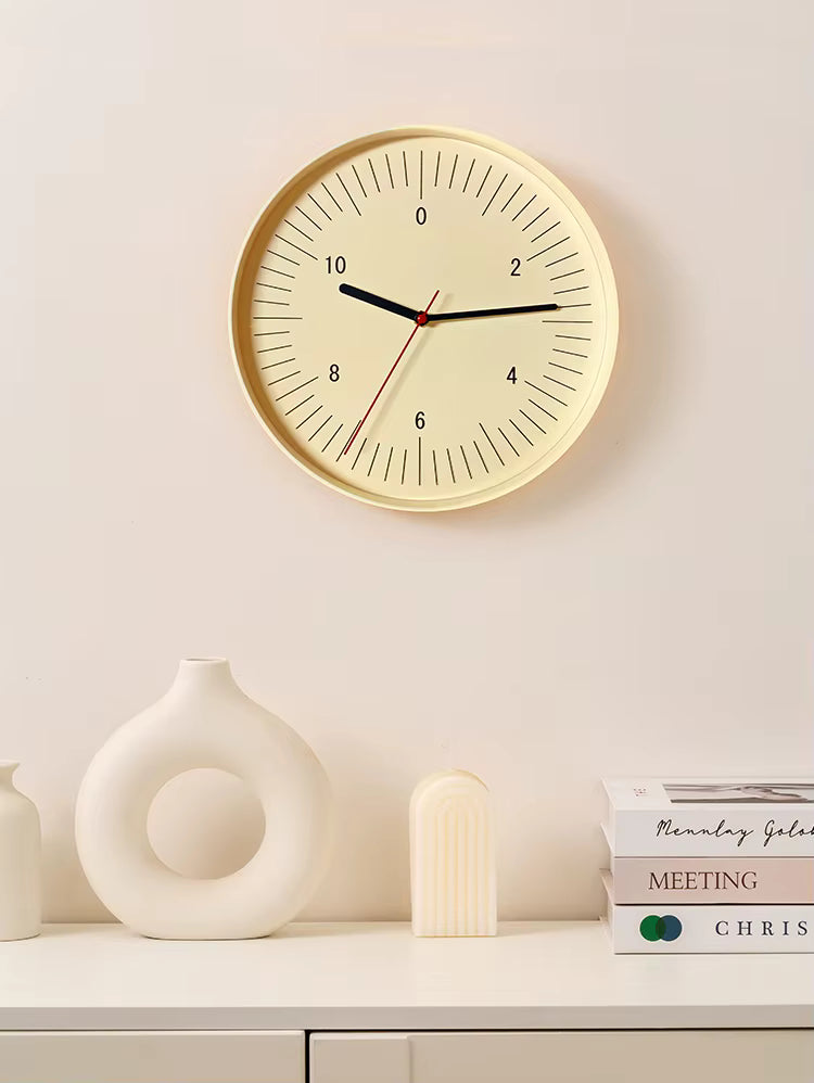Numbers wall clock - Dunmore with a minimalist cream face and bold even numbers, featuring black hour and minute hands, and a red second hand, complemented by modern decor on a white shelf.