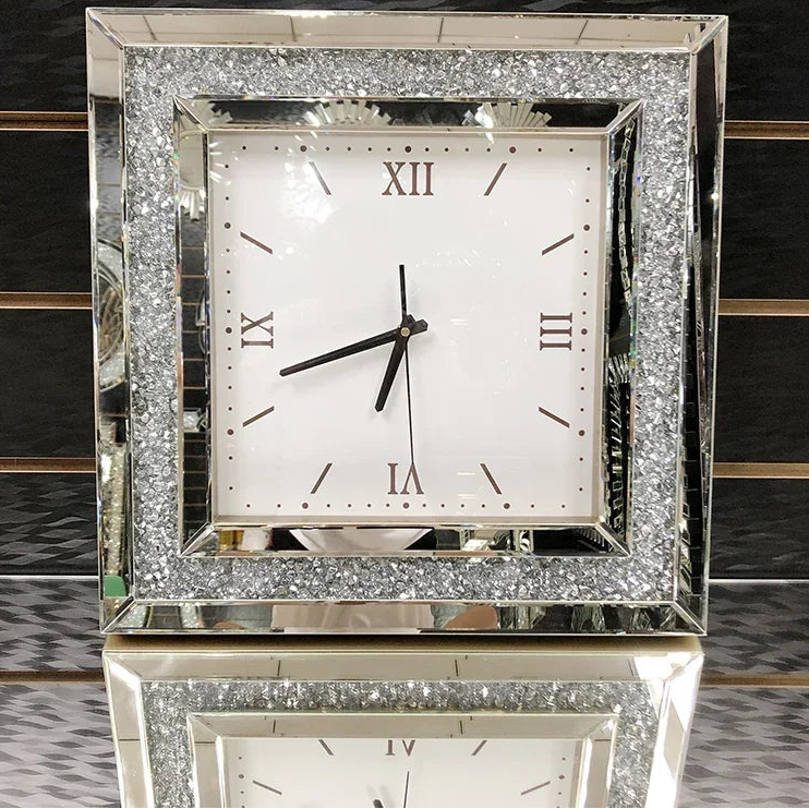 Fancy wall clock - Norwyn features a white face with Roman numerals, black hands, and a mirrored frame with crushed-glass accents, designed to be a room's elegant focal point.