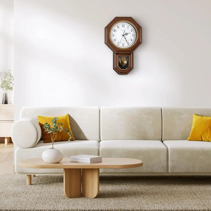 Vintage wall clock pendulum - Heritage: A traditional wooden regulator-style clock with an octagonal frame and pendulum, adding timeless elegance to a minimalist living room setting with neutral tones.