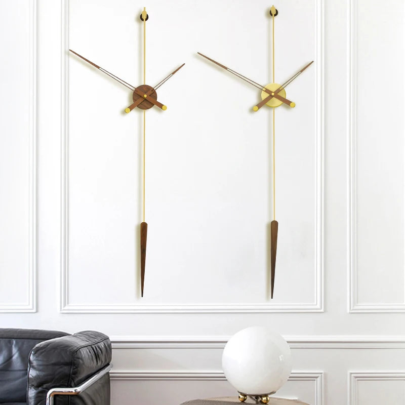 Mid century modern wall clock - Ellroy features a 45-inch walnut baton with slender brass hands and a circular pendulum, creating a minimalist, sculptural design on a white-paneled wall.