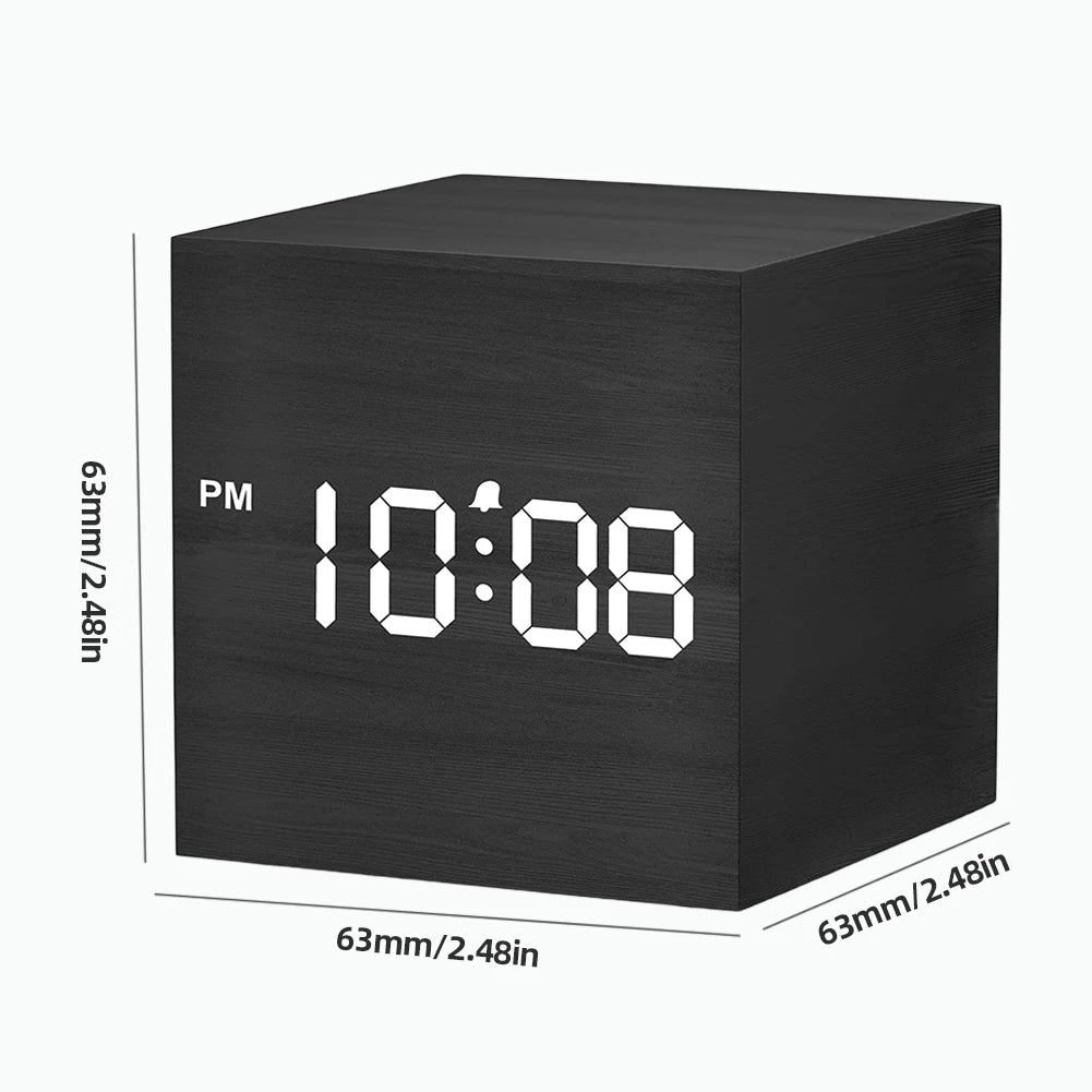 Cube Alarm Clock - Corven: A compact, cube-shaped digital alarm clock with a wood-grain finish and white LED display showing 10:08 PM with an alarm icon, ideal for modern bedside tables.