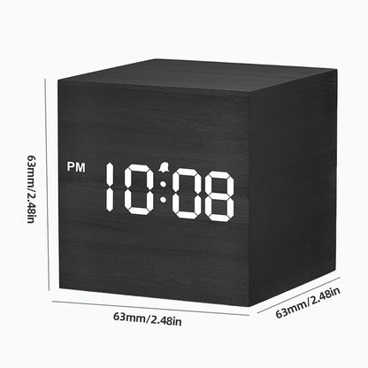 Cube Alarm Clock - Corven: A compact, cube-shaped digital alarm clock with a wood-grain finish and white LED display showing 10:08 PM with an alarm icon, ideal for modern bedside tables.