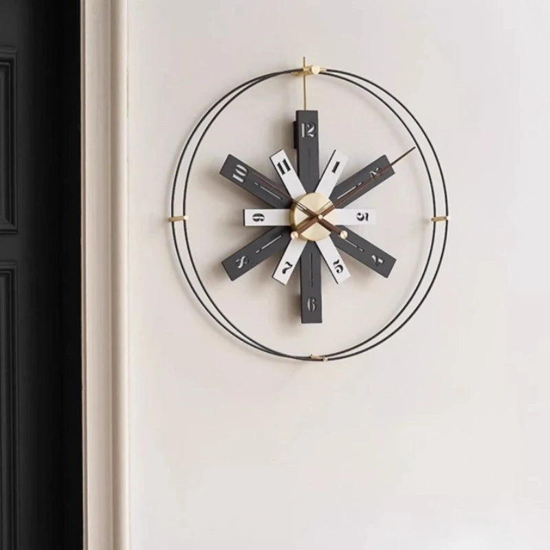 Modern Lounge Wall Clocks - Fremton features twelve rectangular spokes with walnut-brown numerals, brass hands, and a sleek, openwork design, ideal for modern spaces from The Horologista.