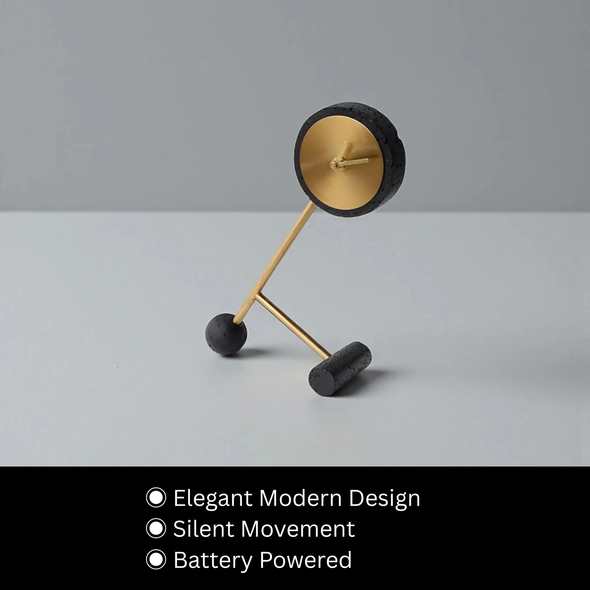 Metal Tabletop Clock - Winsley with an elegant modern design features a matte black and gold open-face showcasing decorative gears, perched on angled gold rods with silent movement, battery-powered, perfect for desks or mantels.