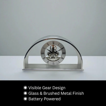 Crystal table clock - Cranley: A modern arch-shaped clock with visible gear mechanism in glass, encased in brushed metal, ideal for special occasions. Battery powered, combining elegance with functionality.
