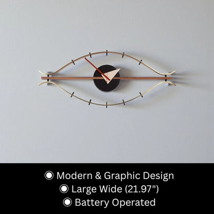 30-inch decorative wall clock - Ashen, featuring a slim, eye-shaped metal frame, central round face, triangular hour hand, red minute hand, and minimalist index marks, exemplifying mid-century industrial style.