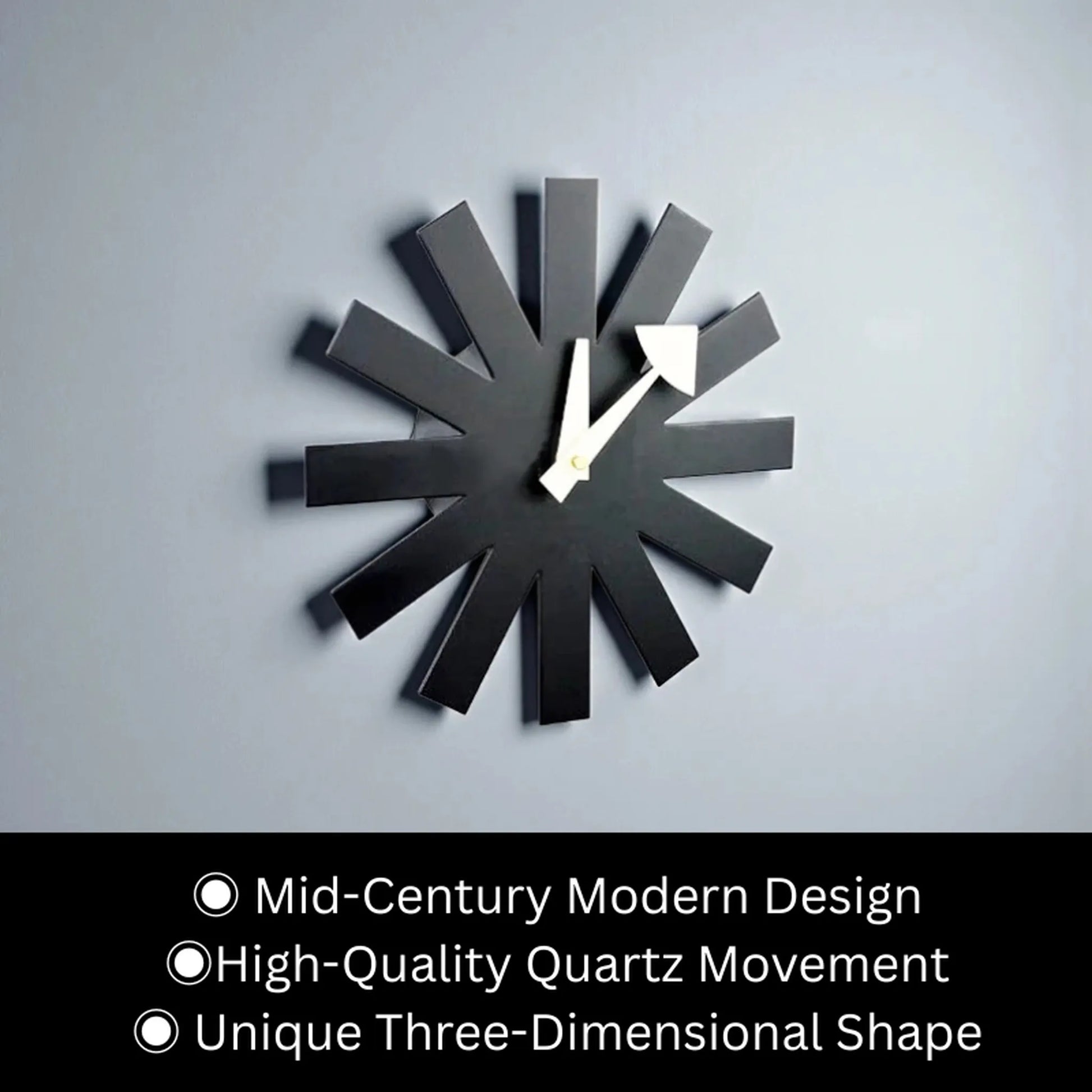 Close-up of charcoal metal spokes and cream geometric hands on black clock