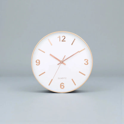 Modern Silent Wall Clock - Densford features a sleek, round design with a white face, gold-tone rim, and elegant numerals, offering a contemporary, silent accent to any room.