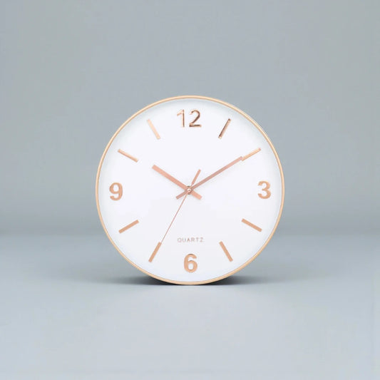 Modern Silent Wall Clock - Densford features a sleek, round design with a white face, gold-tone rim, and elegant numerals, offering a contemporary, silent accent to any room.
