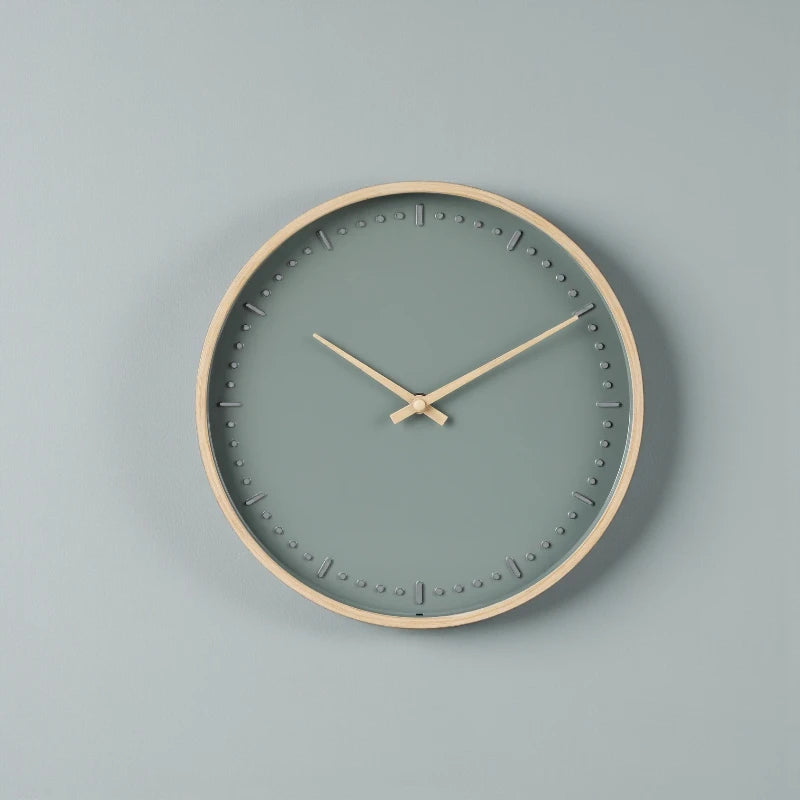 Small modern wall clock - Merrin features a minimalist design with a light wooden frame and teal face, accented by wooden hands and raised hour markers, exemplifying Nordic elegance.