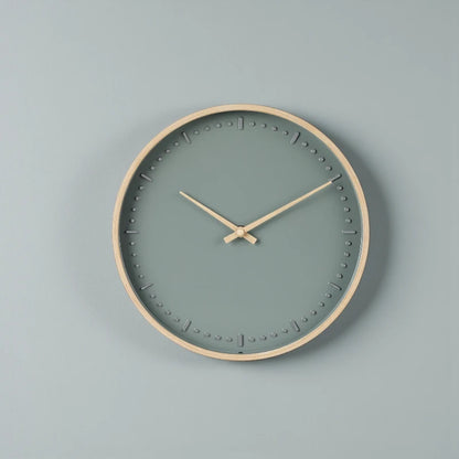Small modern wall clock - Merrin features a minimalist design with a light wooden frame and teal face, accented by wooden hands and raised hour markers, exemplifying Nordic elegance.