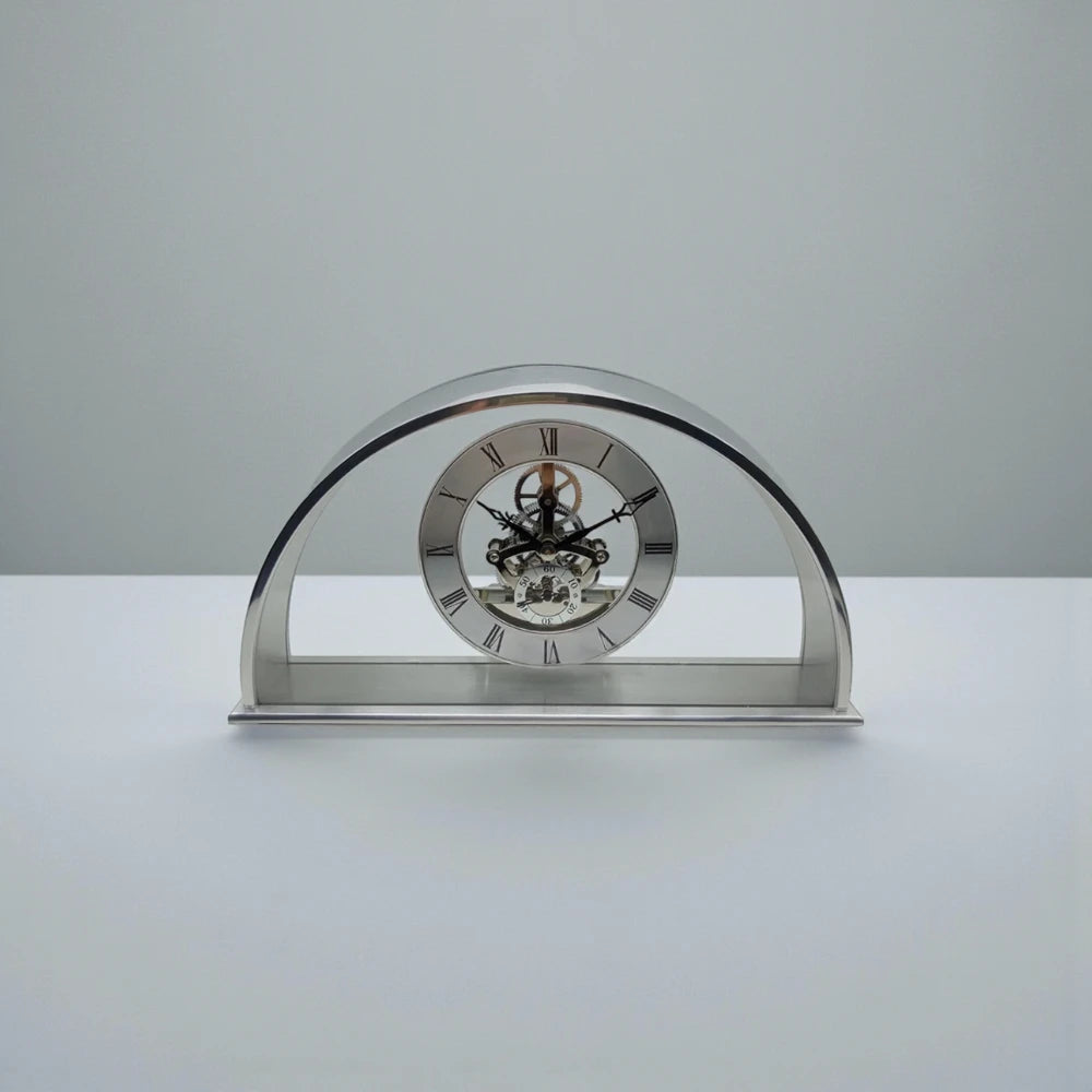 Crystal table clock - Cranley features a polished metal design with a skeleton movement, Roman numeral dial, and visible gears, set on a rectangular base, perfect for special occasions.