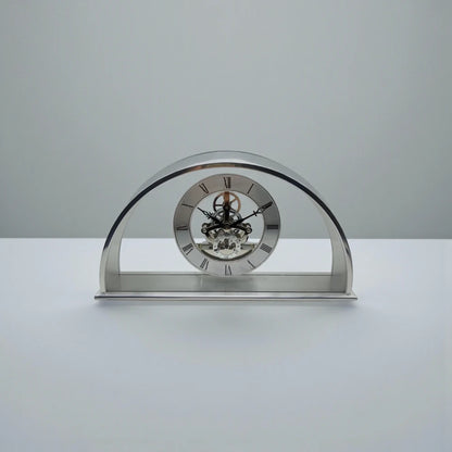 Crystal table clock - Cranley features a polished metal design with a skeleton movement, Roman numeral dial, and visible gears, set on a rectangular base, perfect for special occasions.