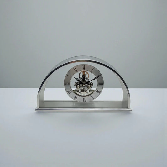 Crystal table clock - Cranley features a polished metal design with a skeleton movement, Roman numeral dial, and visible gears, set on a rectangular base, perfect for special occasions.