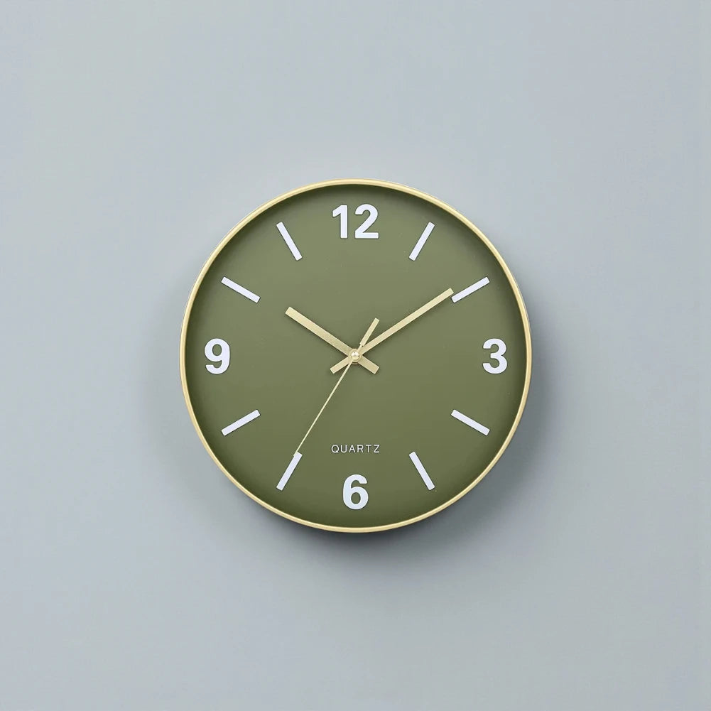 Modern Silent Wall Clock - Densford features a muted olive-green face, slim gold-toned frame, and white numerals. Its minimalist design with silent quartz movement adds elegance to any room.