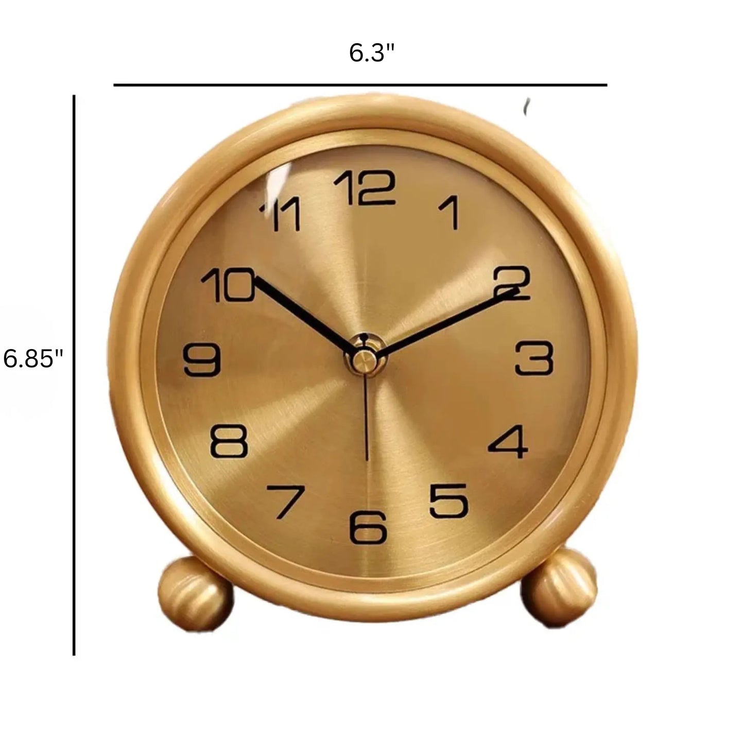 Brass Table Clock - Helric: A small, elegant analog timepiece with a round face, black numerals, and hands, mounted on spherical feet. Its polished brass finish adds a timeless touch to any space.