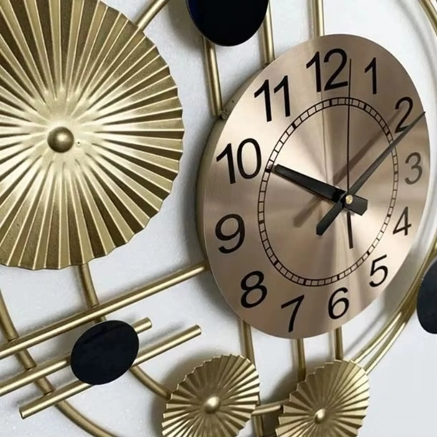 Oversized wall clock modern - Hashford: A gold-tone metal clock with a modern design, floating black numerals, and silent brass hands, enhancing walls with its sculptural elegance and open-face artistry.