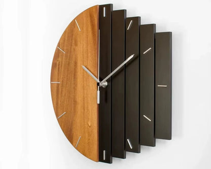 Modern wood wall clock - Clevor features a semi-circular wooden face with metal ticks and staggered dark slats, complemented by minimalist silver hands, creating a striking, curated look for large spaces.