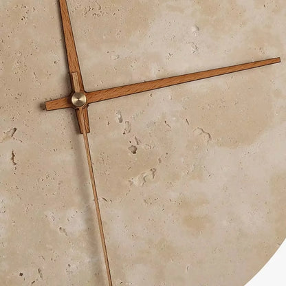 Modern wall clock for living room - Torwyn features a 9-inch travertine face with wooden hands and a warm LED halo, highlighting its minimalist design and unique natural textures.