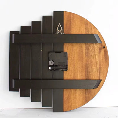 Modern wood wall clock - Clevor, showcasing its slatted-wood back with half-black, half-natural panels, two metal hanging brackets, and central battery housing, perfect for large spaces.