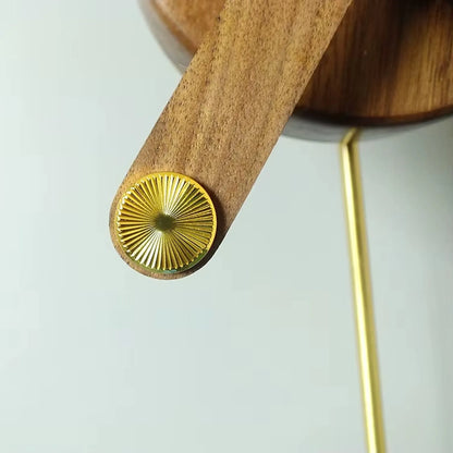 Mid century modern wall clock - Ellroy featuring a sculptural design with a 45-inch walnut baton and slim brass rod, embodying minimalist elegance by The Horologista.