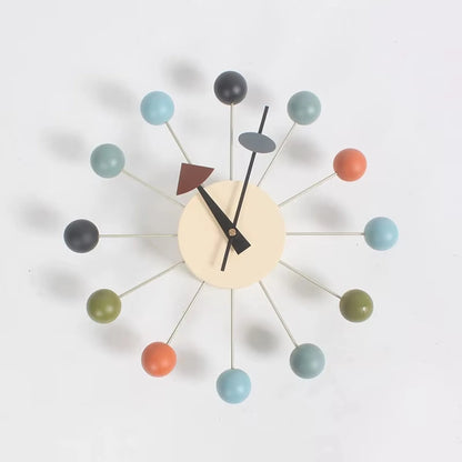 Detail of white clock face with black hands and colorful sphere terminals