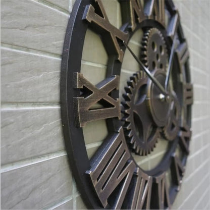 Close-up of the Large metal wall clock - Chronis, featuring a round metal face with cut-out Roman numerals, decorative gears, and a matte grey finish, ideal for industrial and contemporary interiors.
