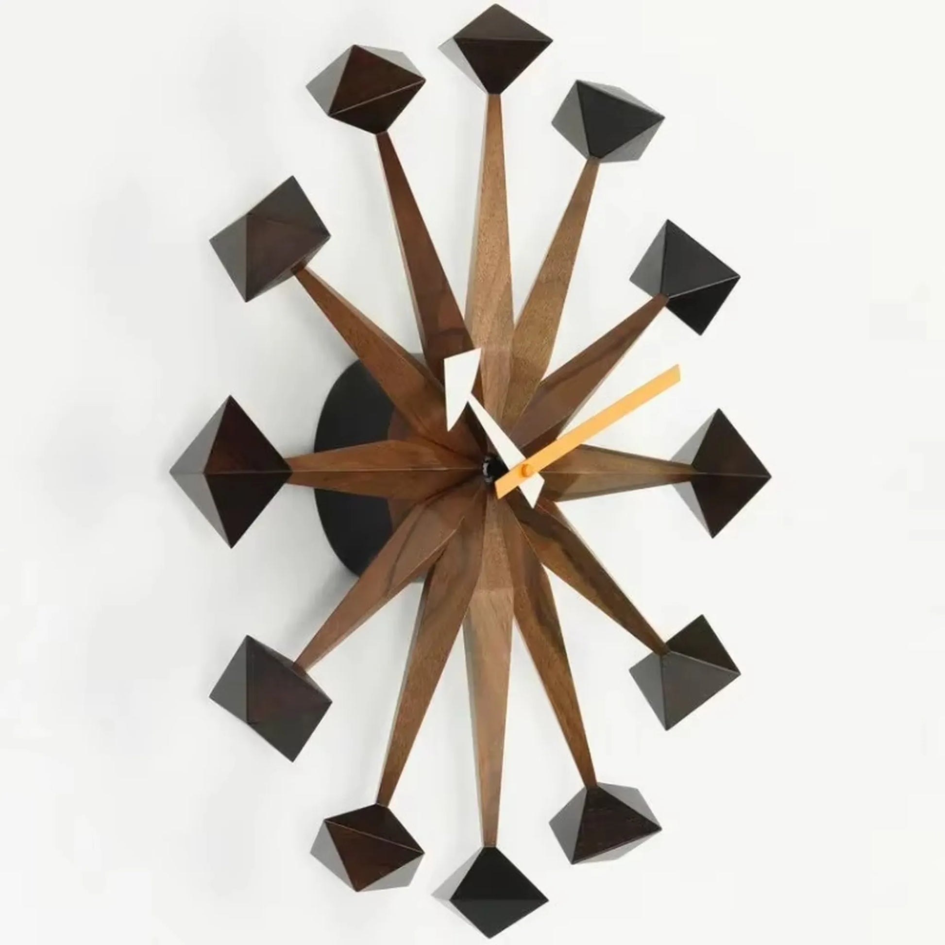 Decorative wall clocks modern - Drayen: A mid-century design with 12 wooden spokes and polyhedral tips, featuring white and orange clock hands, ideal for contemporary spaces.