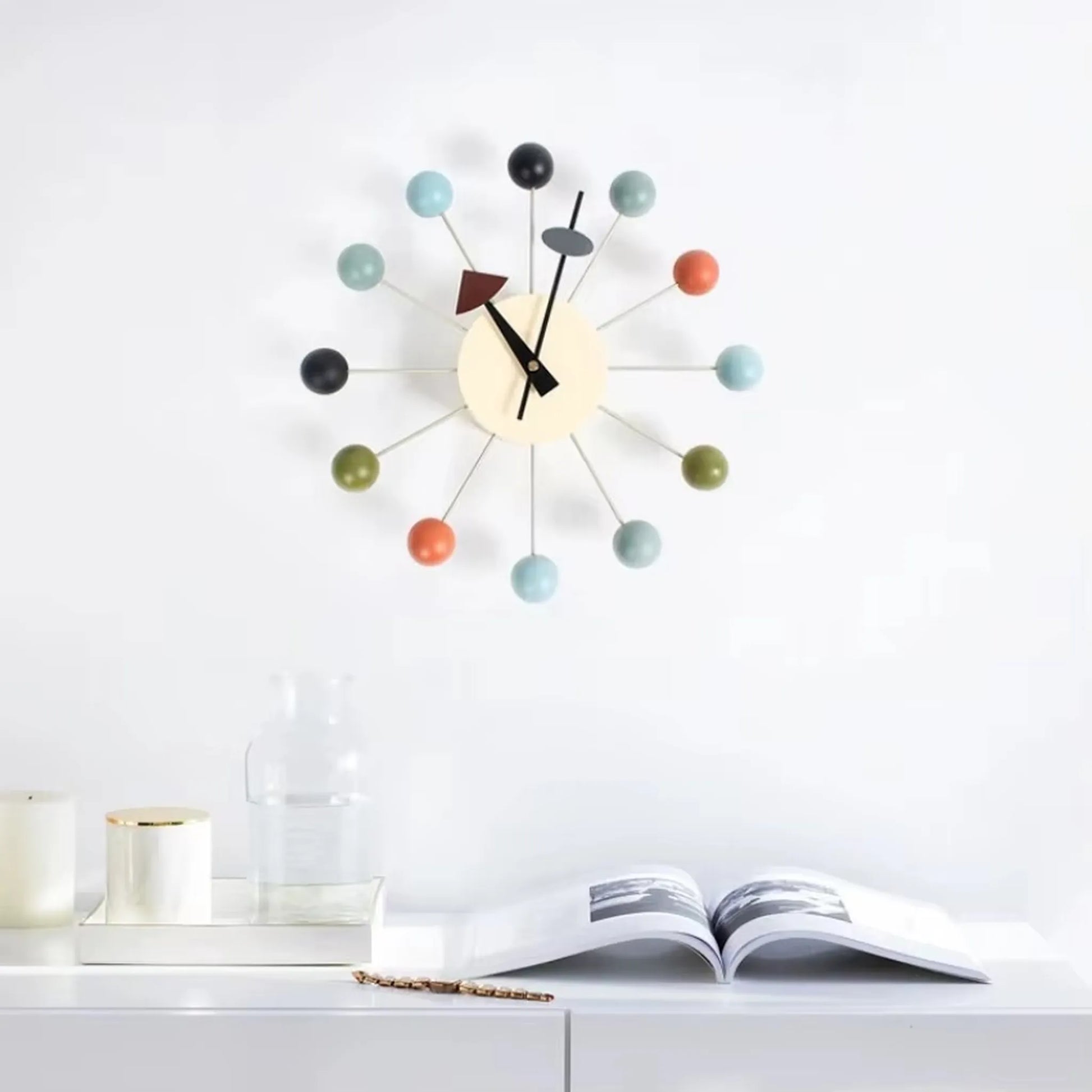 Wall clock styled with mid-century furniture and geometric accent pillows
