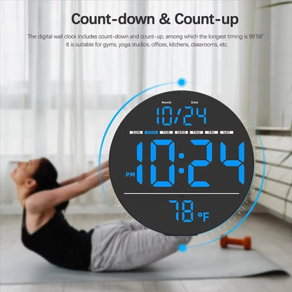 Digital Wall Clocks - Hadley: Round digital clock with blue LED display showing date, day, time, and temperature. Highlighted features include countdown/up timer, ideal for gyms or offices.